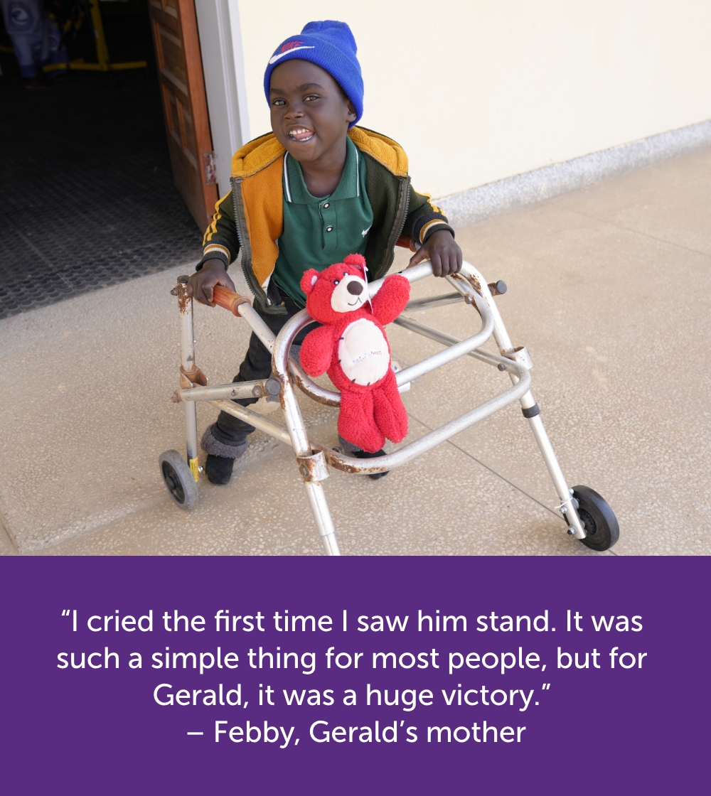 Gerald standing with a walking frame smiling.