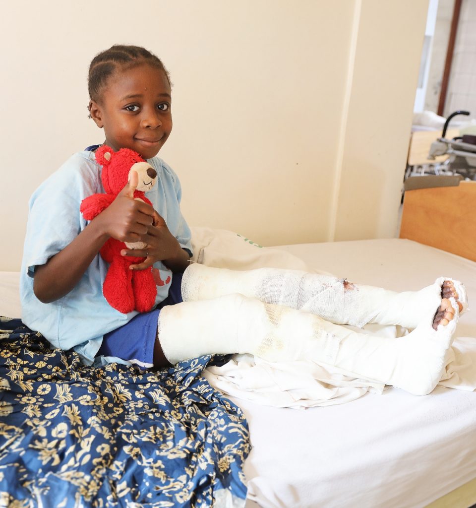 Child with a bear sitting after surgery