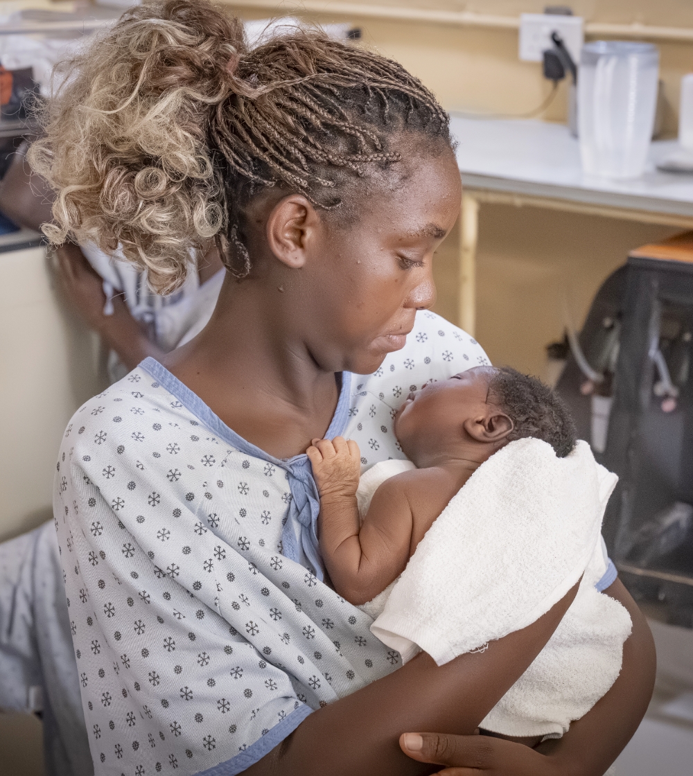 A mother holding her newborn child