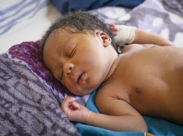 A sleeping baby on her back