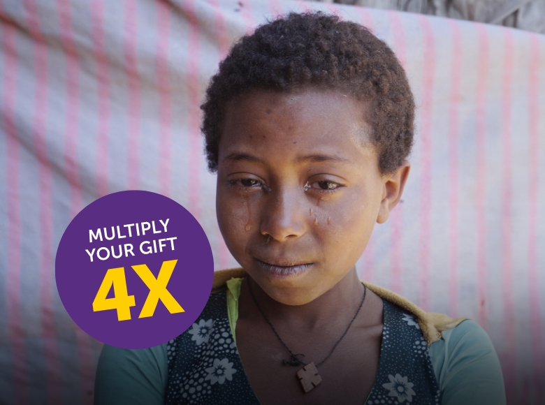 A girl with weepy eyes, with a purple circle above her left shoulder reading "multiply your gift 4 times.".