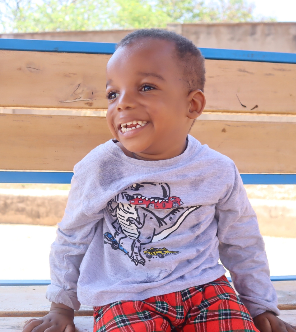 Geofrey smiling at House of Hope.