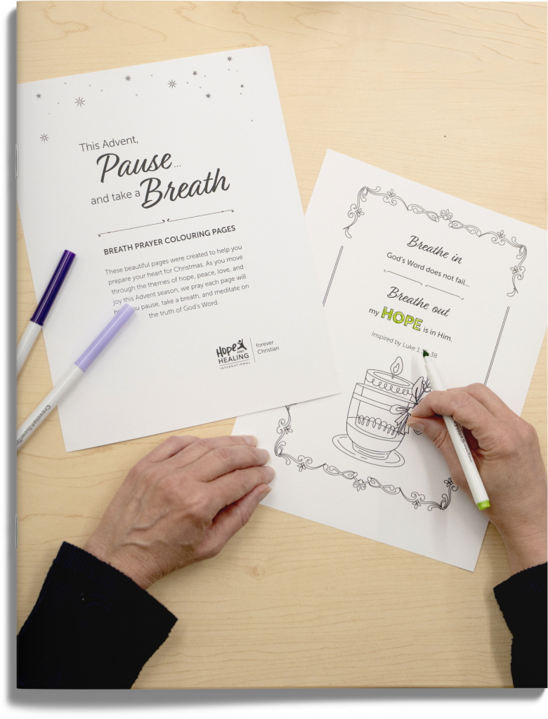 Hands using markers to colour breath prayer colouring pages.