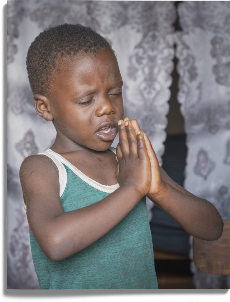 A young child praying.